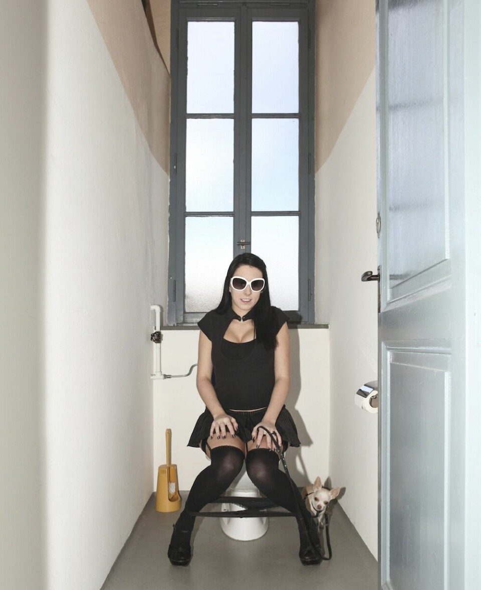 young woman with sunglasses sitting on the toilet, interior